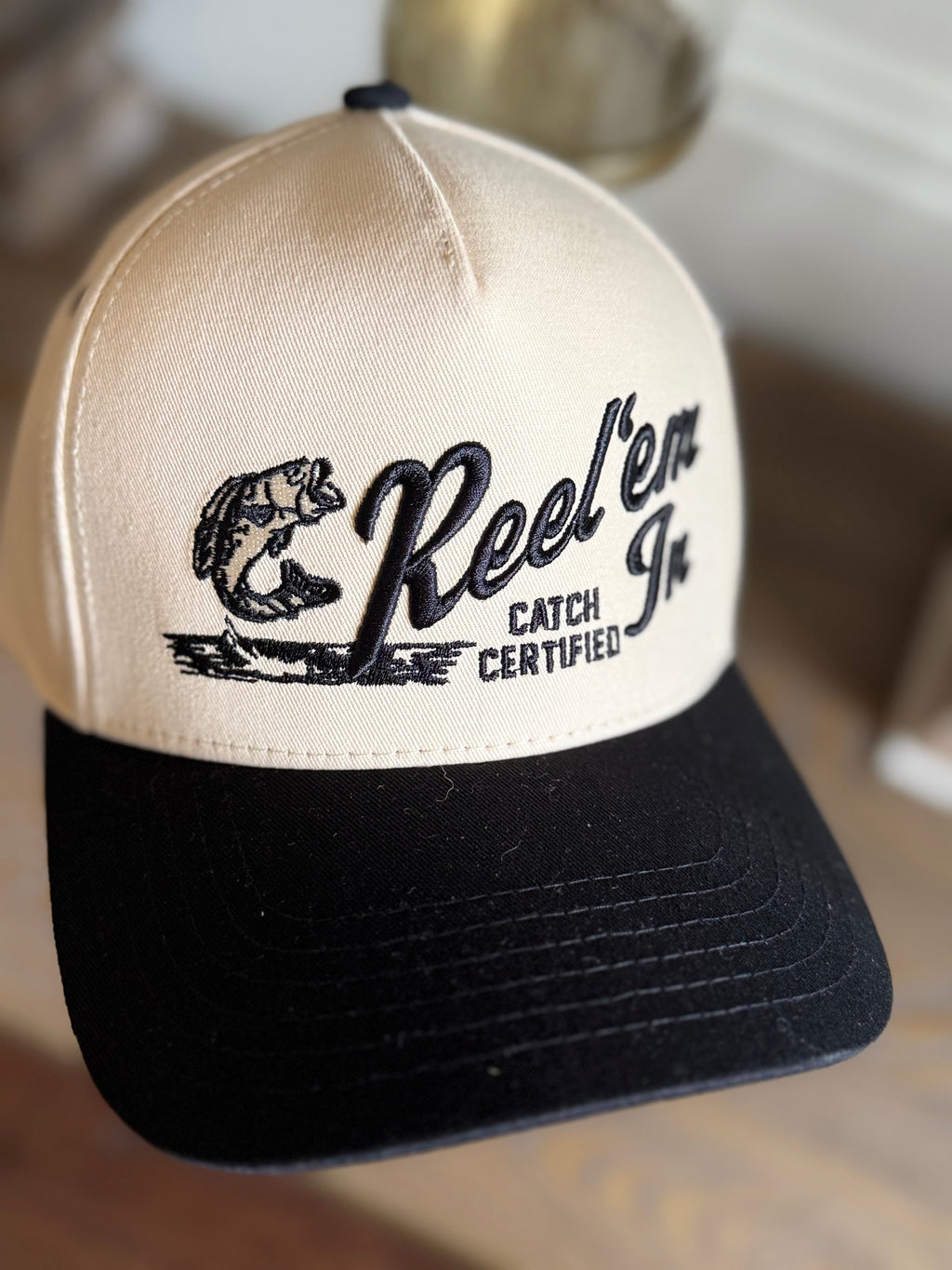 REEL EM IN BLACK/TAN