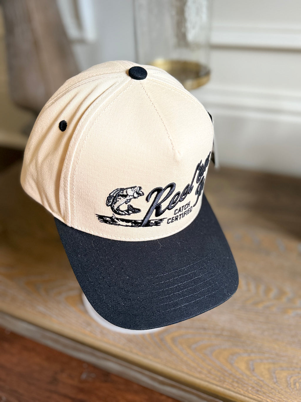 REEL EM IN BLACK/TAN